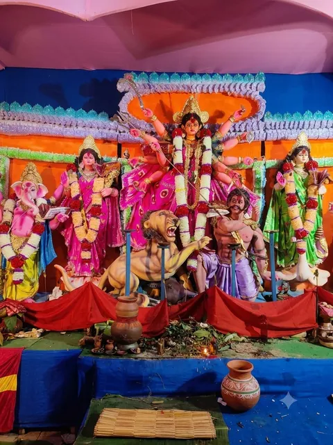 Durga Puja pandal idol with pink and orange decor